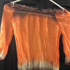 Orange, off the shoulder, sheer blouse. French.